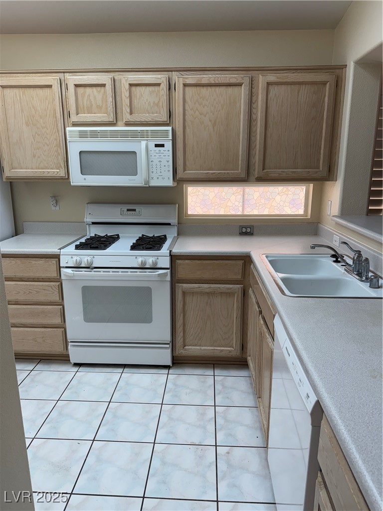 495 Edgefield Ridge Place Henderson, NV 89012 - Photo 2 of 16 Kitchen featuring range, dishwasher, light countertops, and light brown cabinets