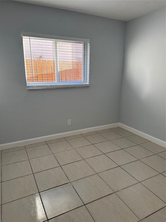 3050 Northeast 5th Terrace, Unit 6 Wilton Manors, FL 33334 - Photo 12 of 22 an empty room with a window