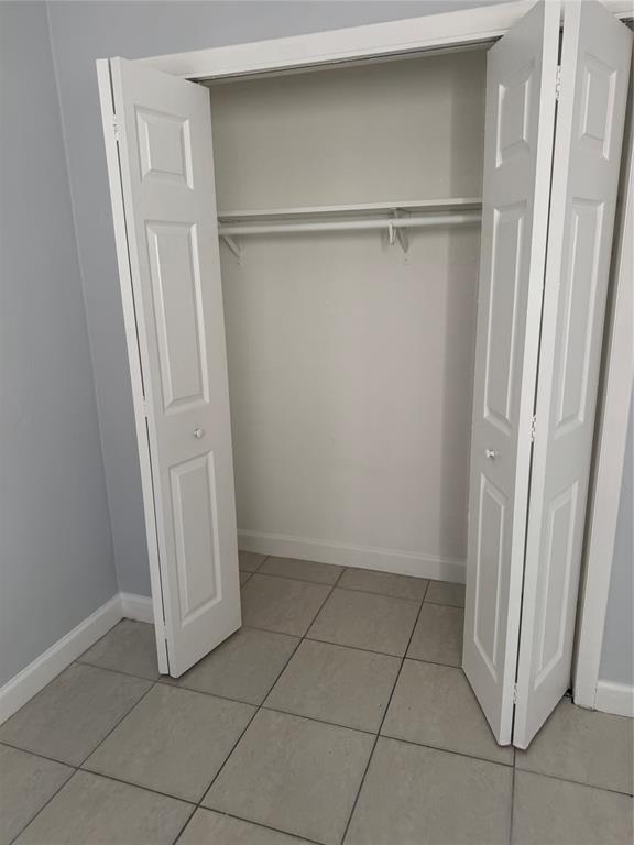3050 Northeast 5th Terrace, Unit 6 Wilton Manors, FL 33334 - Photo 13 of 22 a view of closet area with empty racks