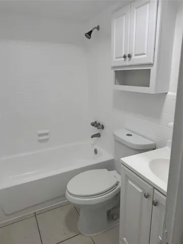 a white toilet sitting next to a bath tub