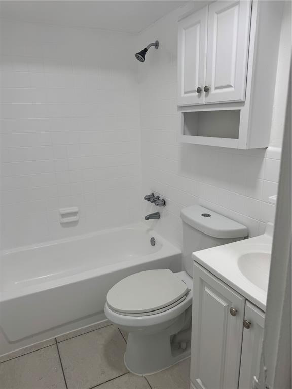 3050 Northeast 5th Terrace, Unit 6 Wilton Manors, FL 33334 - Photo 15 of 22 a white toilet sitting next to a bath tub