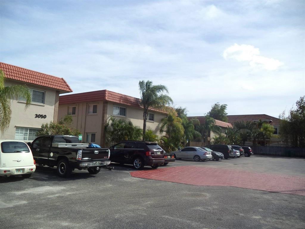 3050 Northeast 5th Terrace, Unit 6 Wilton Manors, FL 33334 - Photo 20 of 22 a car parked in front of a house