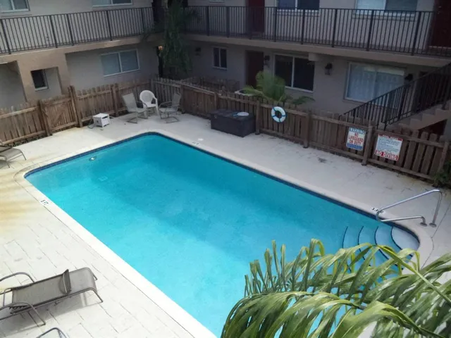 a view of a backyard with plants and a patio