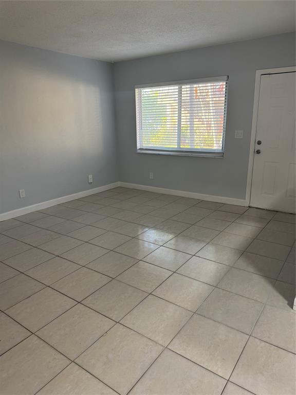 3050 Northeast 5th Terrace, Unit 6 Wilton Manors, FL 33334 - Photo 4 of 22 an empty room with windows