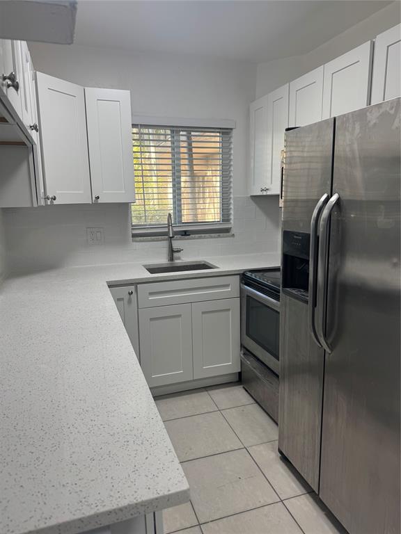 3050 Northeast 5th Terrace, Unit 6 Wilton Manors, FL 33334 - Photo 9 of 22 a kitchen with a sink a refrigerator and window