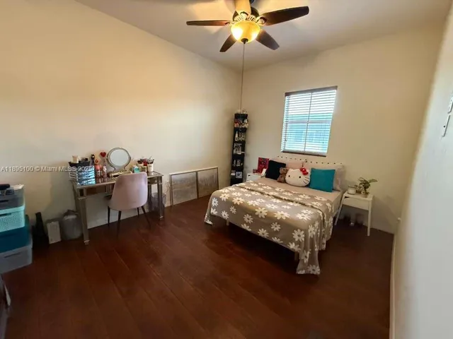 a bedroom with a bed a table and chair