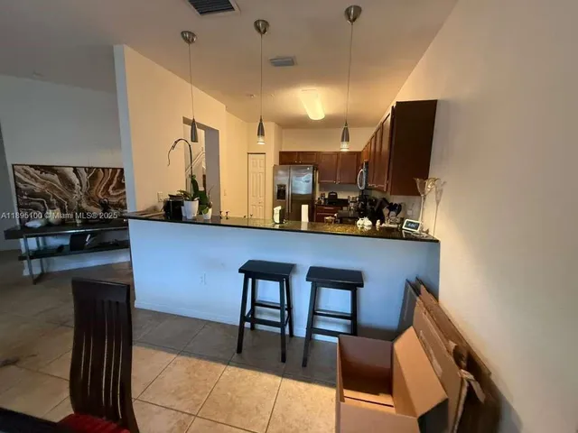 a dining room with furniture and a flat screen tv