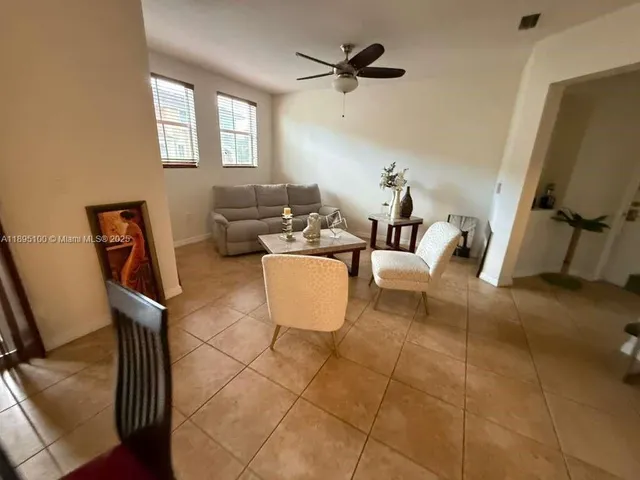 a living room with furniture a window and a flat screen tv
