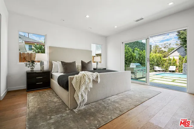 a bed room with a bed and a large window