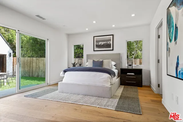 a spacious bedroom with a large bed and a window