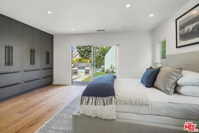 a bedroom with a large bed and a large window
