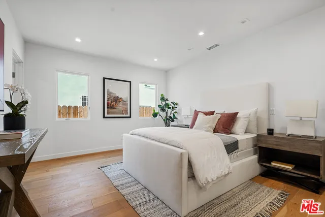 a bedroom with a bed and a desk