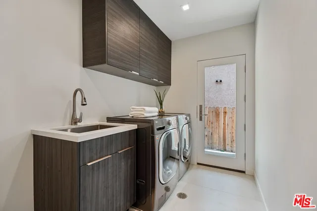 a view of a sink with washer and dryer