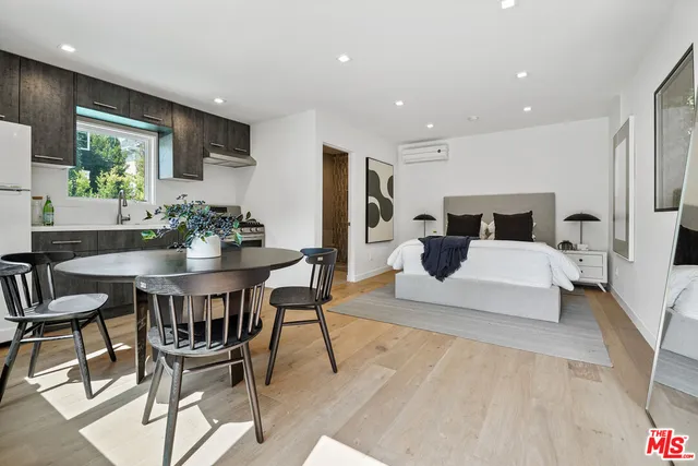 a living room with furniture and a dining table