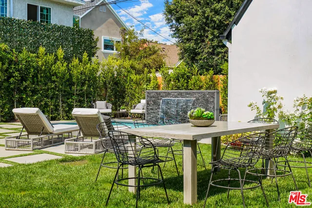 a view of an chairs and table in the patio