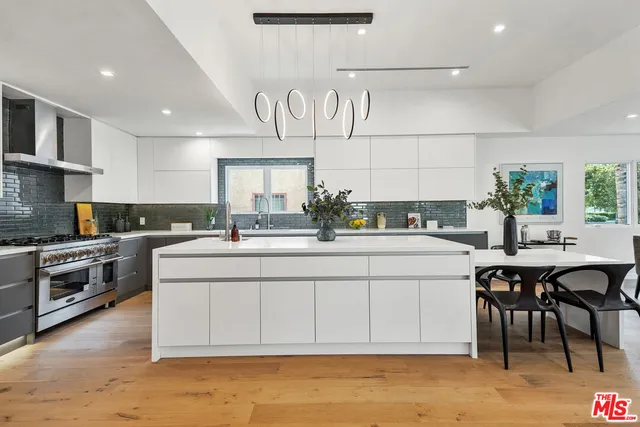 a kitchen with a sink and a stove top oven