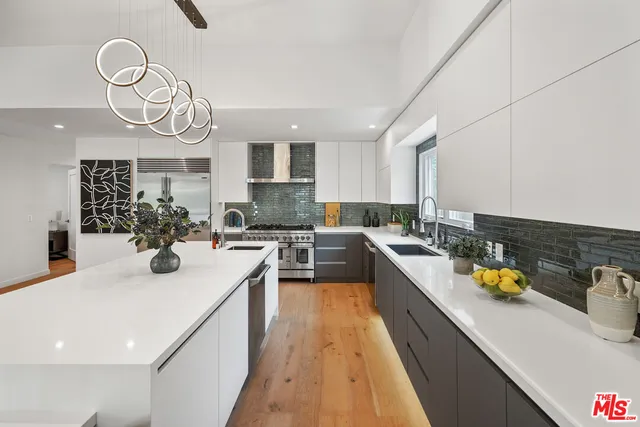 a kitchen with a sink white cabinets and counter space