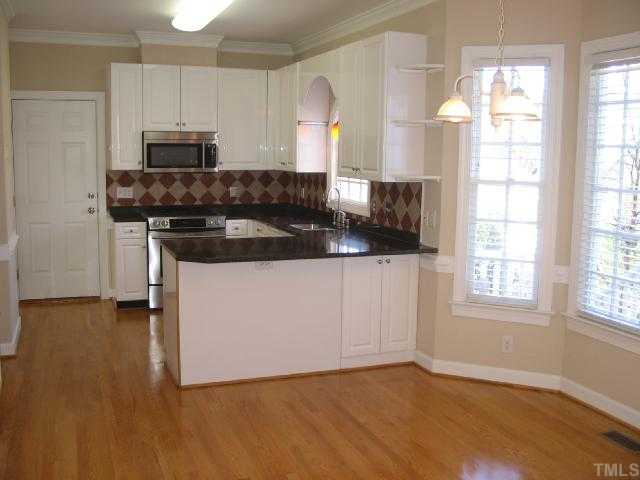 104 Lyncroft Lane Cary, NC 27519 - Photo 3 of 12 Features newer Ultra Craft Cabinets, Hardwood floor, Breakfast Area with Bay Window and More!