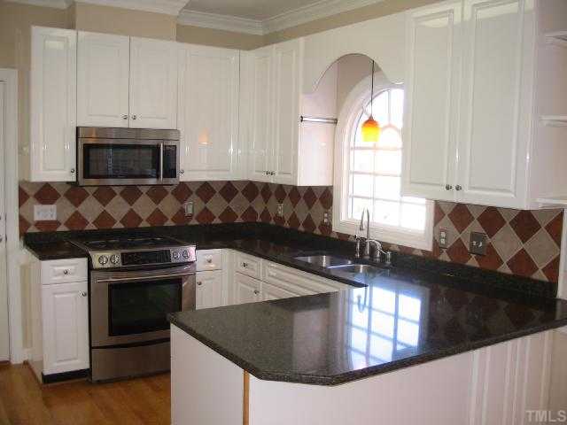 104 Lyncroft Lane Cary, NC 27519 - Photo 4 of 12 Stainless Steel Jenn- Air Appliances, Gas Range, Quartz Countertops, Built In Microwave, Tile Splash Back, Pantry, and More!