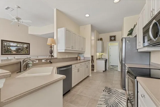 a kitchen with sink cabinets and window