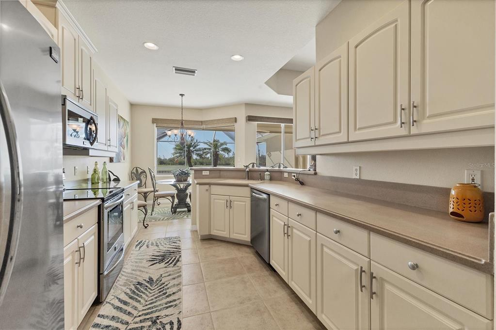 105 Westwind Drive Placida, FL 33946 - Photo 16 of 40 a kitchen with sink cabinets and window