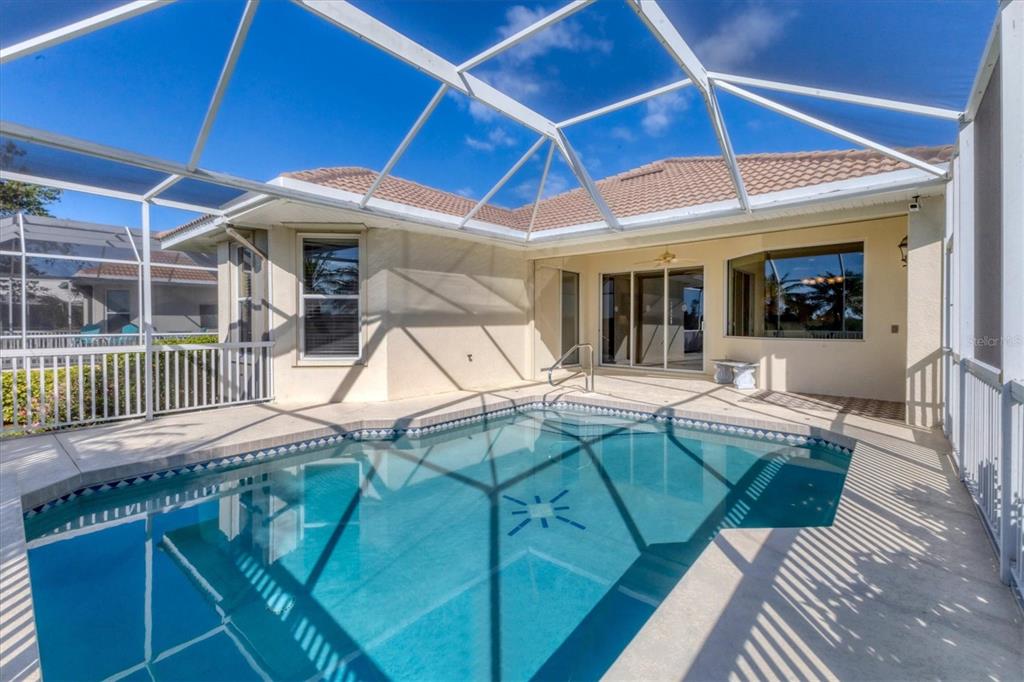 105 Westwind Drive Placida, FL 33946 - Photo 21 of 40 a view of a patio with a table and chairs under an umbrella