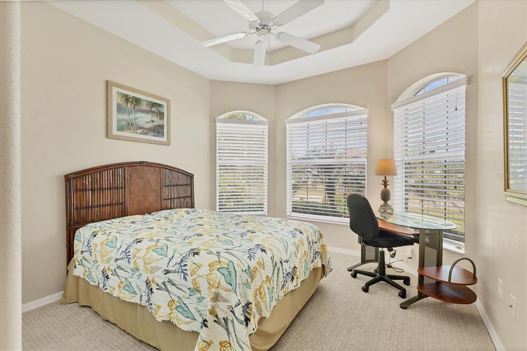 105 Westwind Drive Placida, FL 33946 - Photo 27 of 40 a bedroom with a bed and a desk
