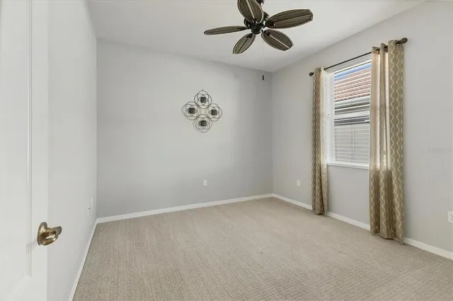 a view of a livingroom with a ceiling fan and window