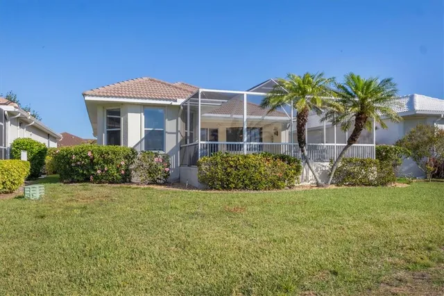 an aerial view of residential houses with yard and lake view