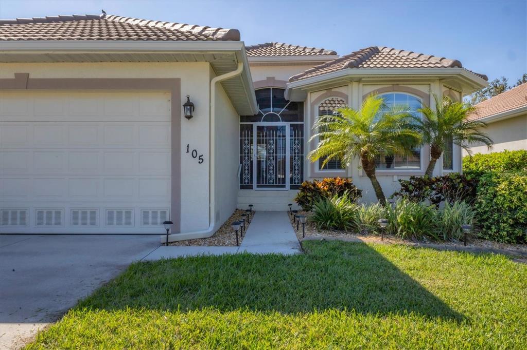 105 Westwind Drive Placida, FL 33946 - Photo 7 of 40 a front view of a house with garden
