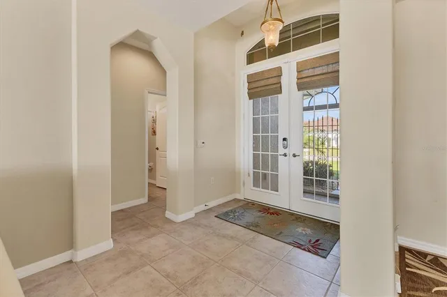 a living room with furniture and a floor to ceiling window