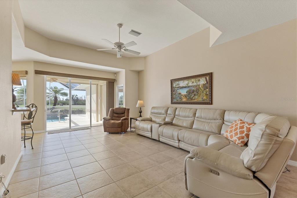 105 Westwind Drive Placida, FL 33946 - Photo 9 of 40 a living room with furniture and a floor to ceiling window