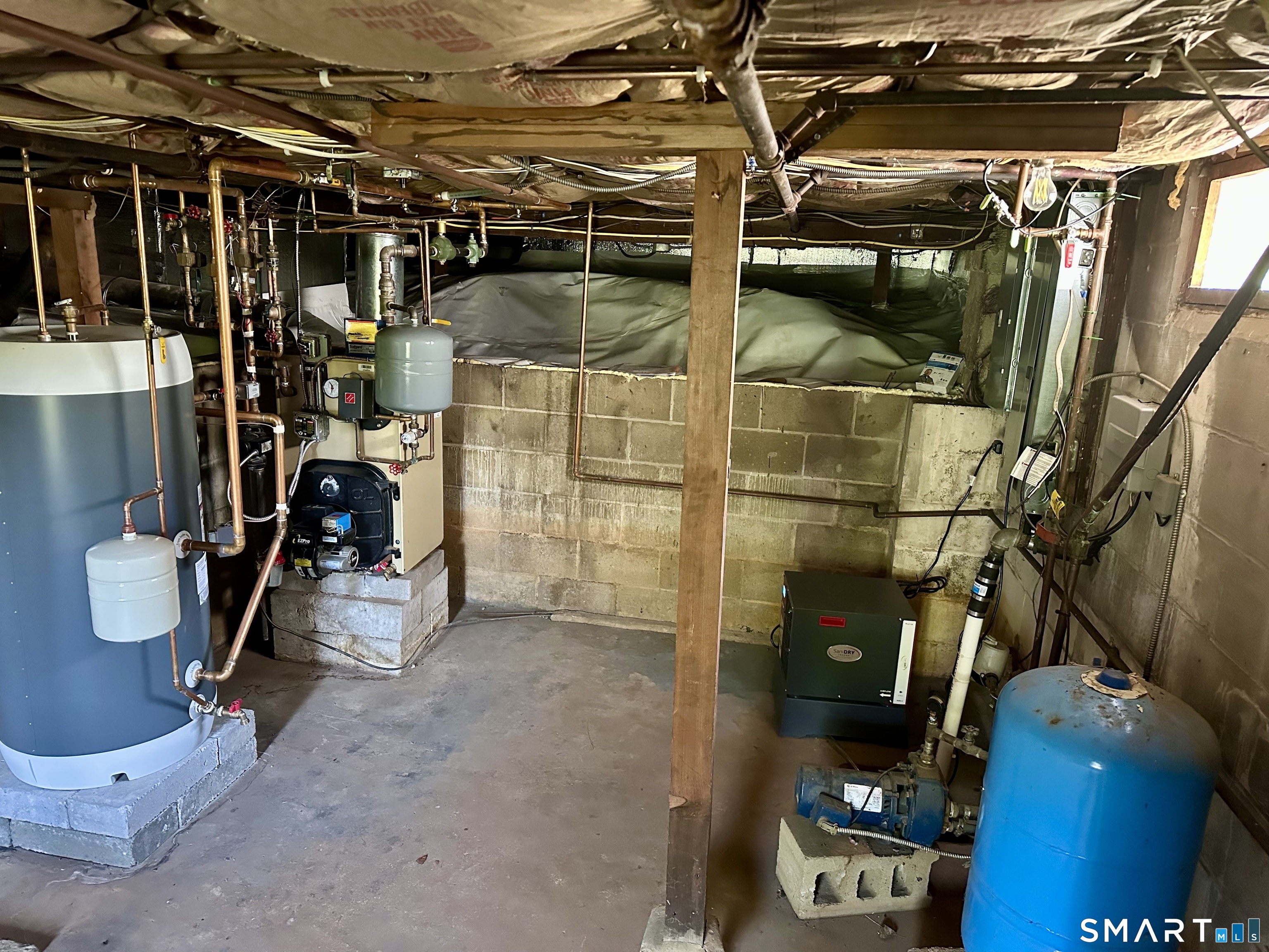 36 Attawan Road East Lyme, CT 06357 - Photo 36 of 40 Basement with Mechanicals: Electric Panels, Boiler, Oil Tank, Dehumidifier, Thermostatic Hot Water Heater, Sump Pump. Sealed Liner throughout crawlspace areas.