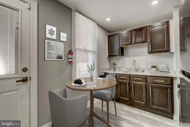 a kitchen with stainless steel appliances granite countertop a stove microwave and sink