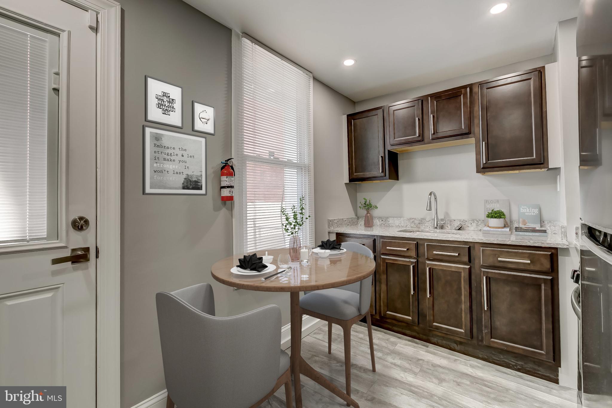 3600 Keswick Road, Unit A Baltimore, MD 21211 - Photo 30 of 43 a kitchen with stainless steel appliances kitchen island granite countertop a sink and cabinets