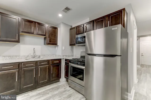 an empty room with wooden floor and a window