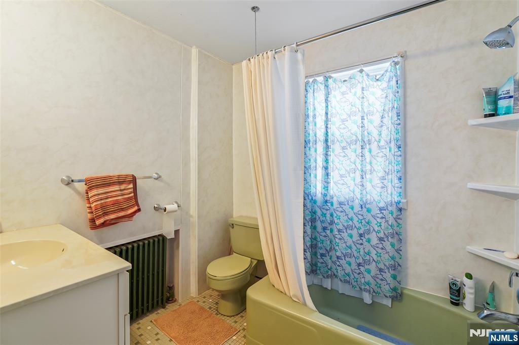 25 Ralph Street Bergenfield, NJ 07621 - Photo 10 of 17 a bathroom with a toilet a sink and a shower