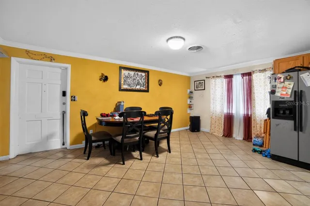 a view of a dining room with furniture and chandelier