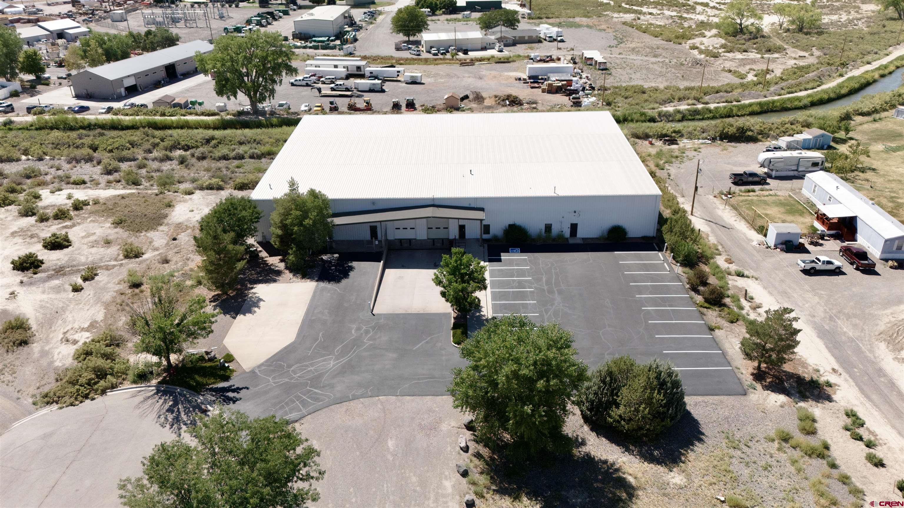 12045 6300 Road Montrose, CO 81401 - Photo 1 of 8 an aerial view of a house with a yard and lake