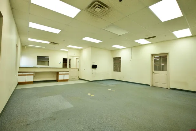 a view of an empty room with kitchen