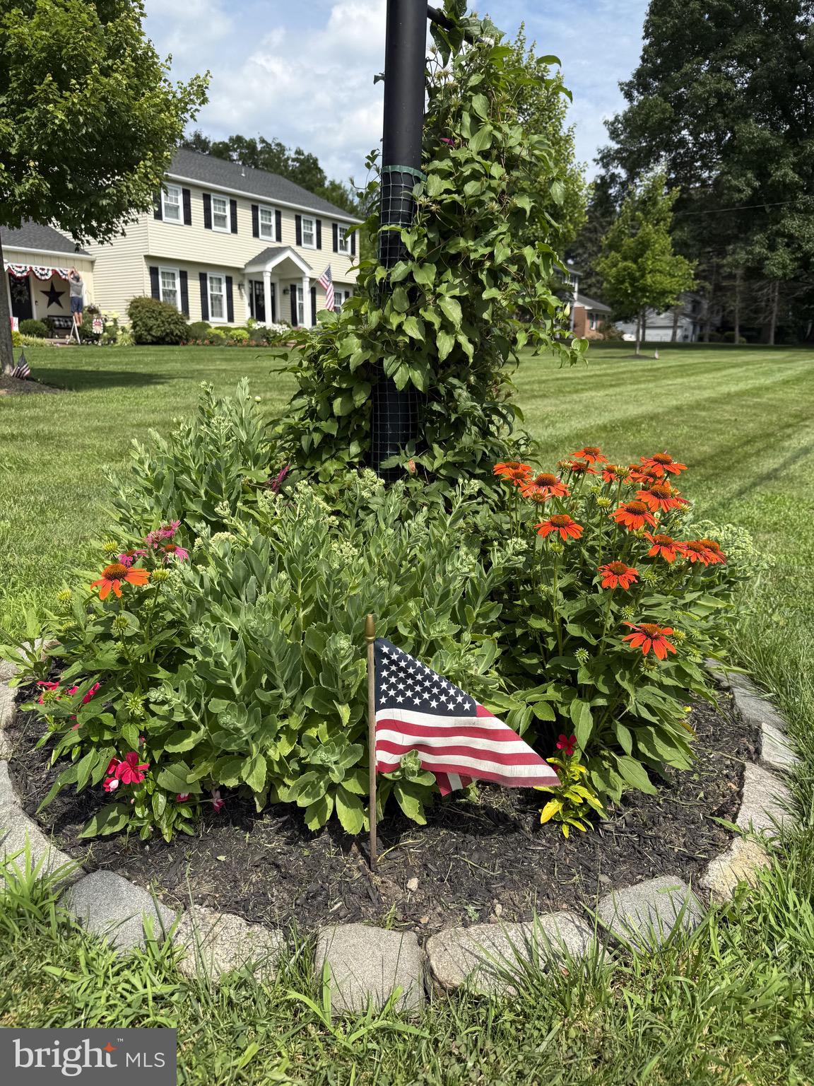 225 Chestnut Valley Drive Doylestown, PA 18901 - Photo 44 of 46 a backyard of a house with a garden and outdoor seating