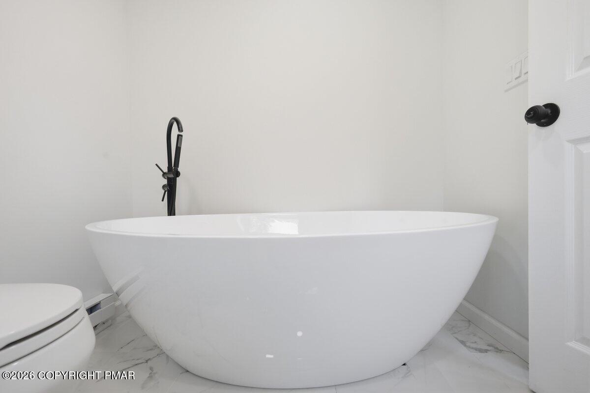 155 Blooming Grove Road Hawley, PA 18428 - Photo 33 of 41 a white bath tub sitting in a bathroom