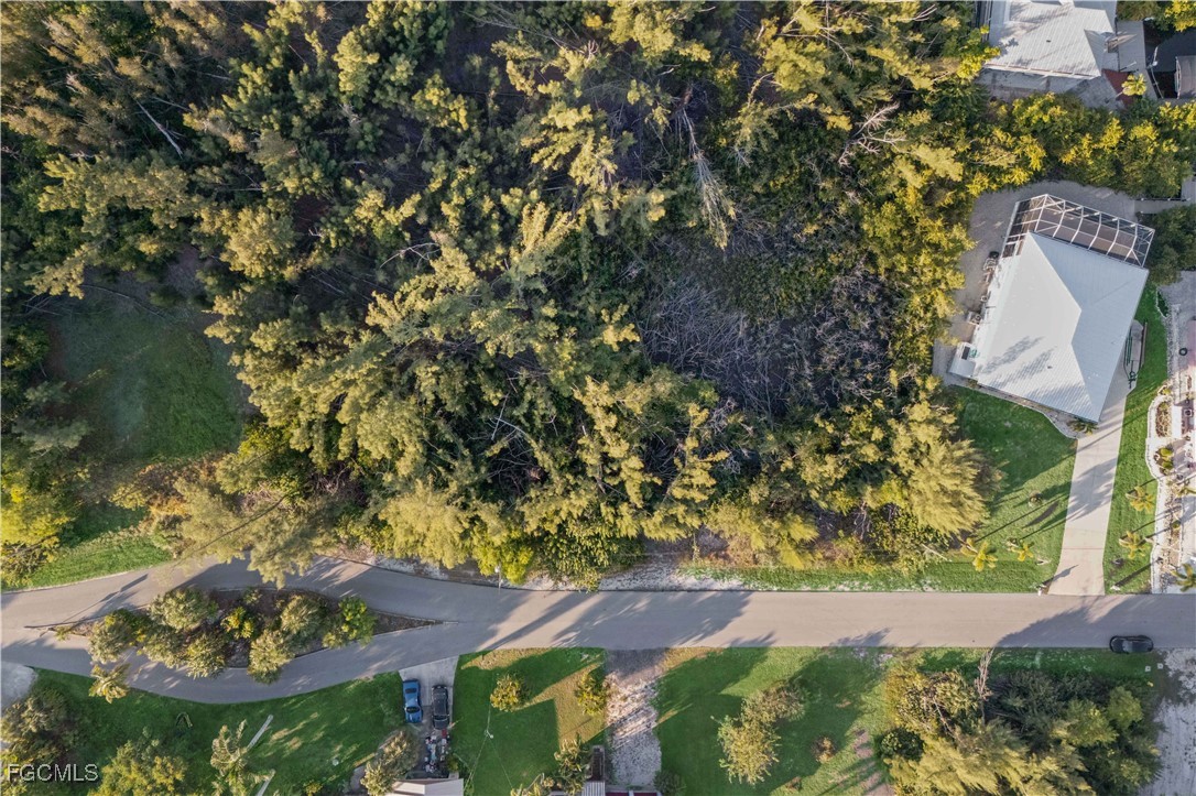 5480 Ann Arbor Drive Bokeelia, FL 33922 - Photo 8 of 12 an aerial view of residential house with outdoor space and trees all around