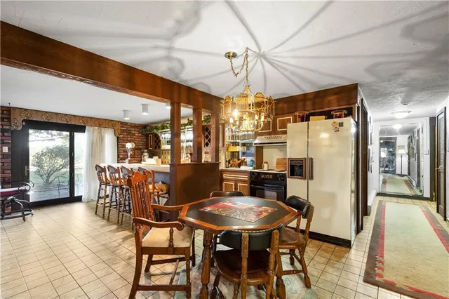 an aerial view of residential houses with outdoor space and trees