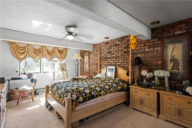 an aerial view of residential houses with outdoor space and trees