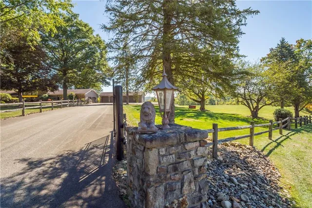 a living room with fireplace furniture and a large window
