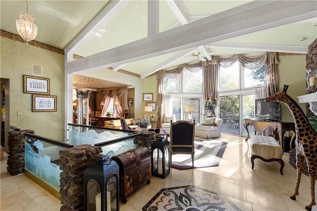 a kitchen with a sink stools a counter space and cabinets