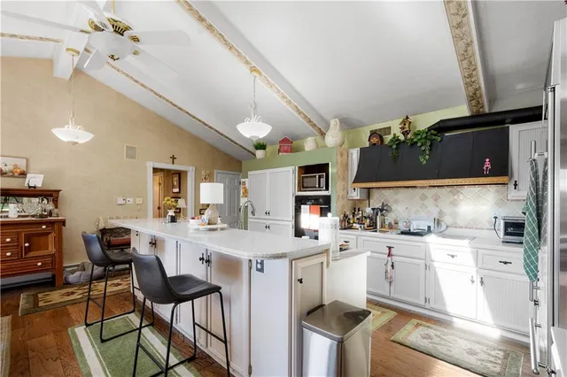 a living room with furniture a ceiling fan and a rug
