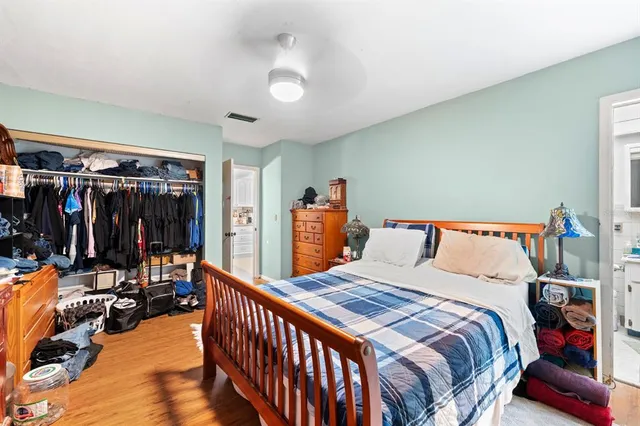 a bedroom with a bed and a walk in closet