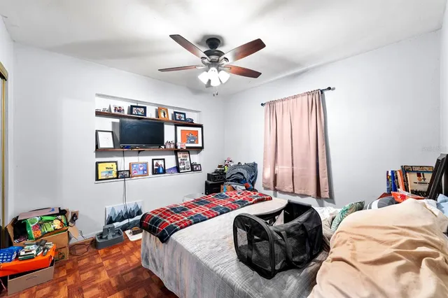 a bedroom with a bed furniture and a flat screen tv